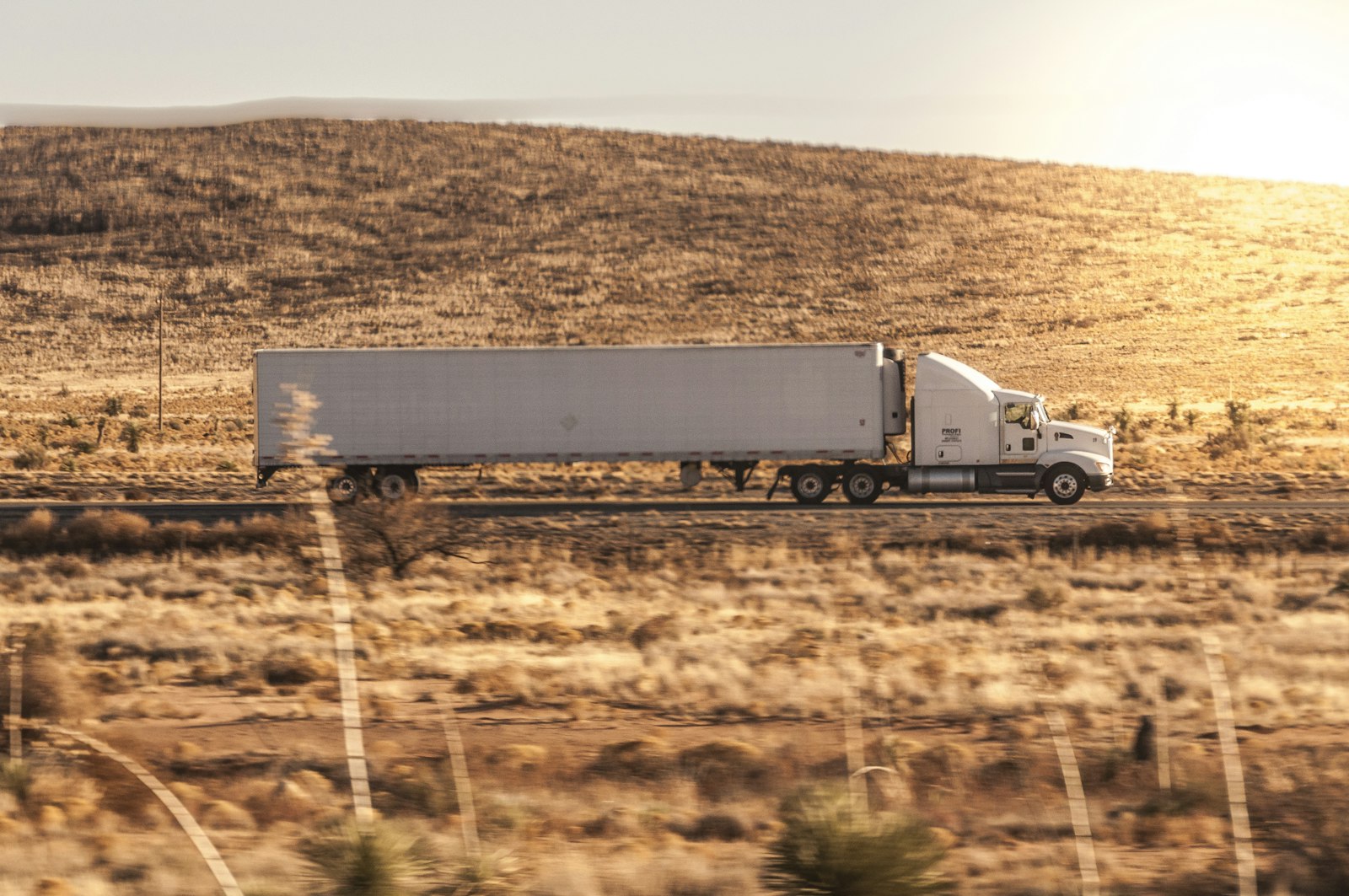 White box trailer coupled to a tractor unit on a highway